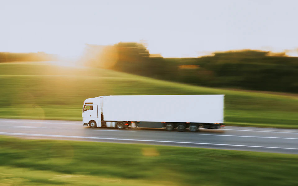 A lorry on the motorway at sunset